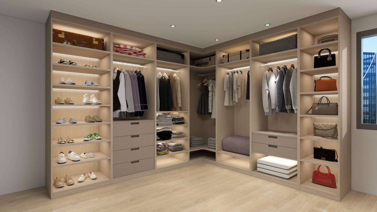 Modern L-shaped walk-in closet with built-in shelving, shoe racks, hanging rods, drawers, and organized clothing and accessories display