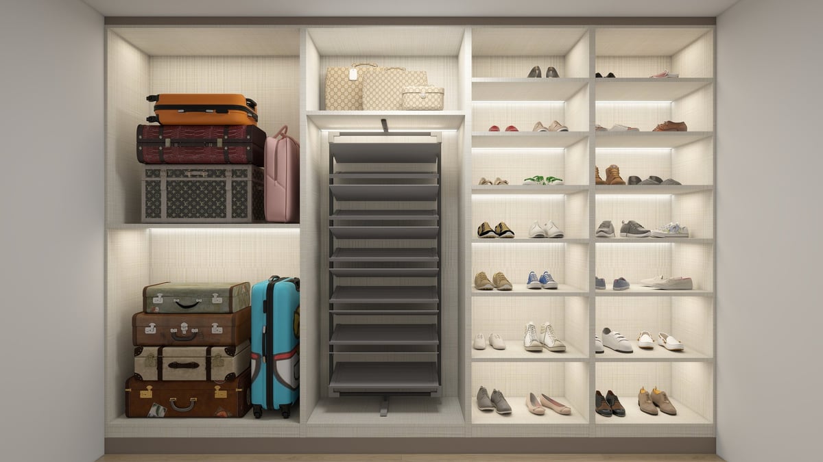 Modern closet organization with stacked vintage suitcases, shoe shelving, storage boxes, and a louvered panel on white shelving units.