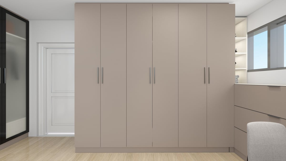 Modern bedroom with large beige built-in wardrobe, white entrance door, wooden floor, and contemporary furnishings