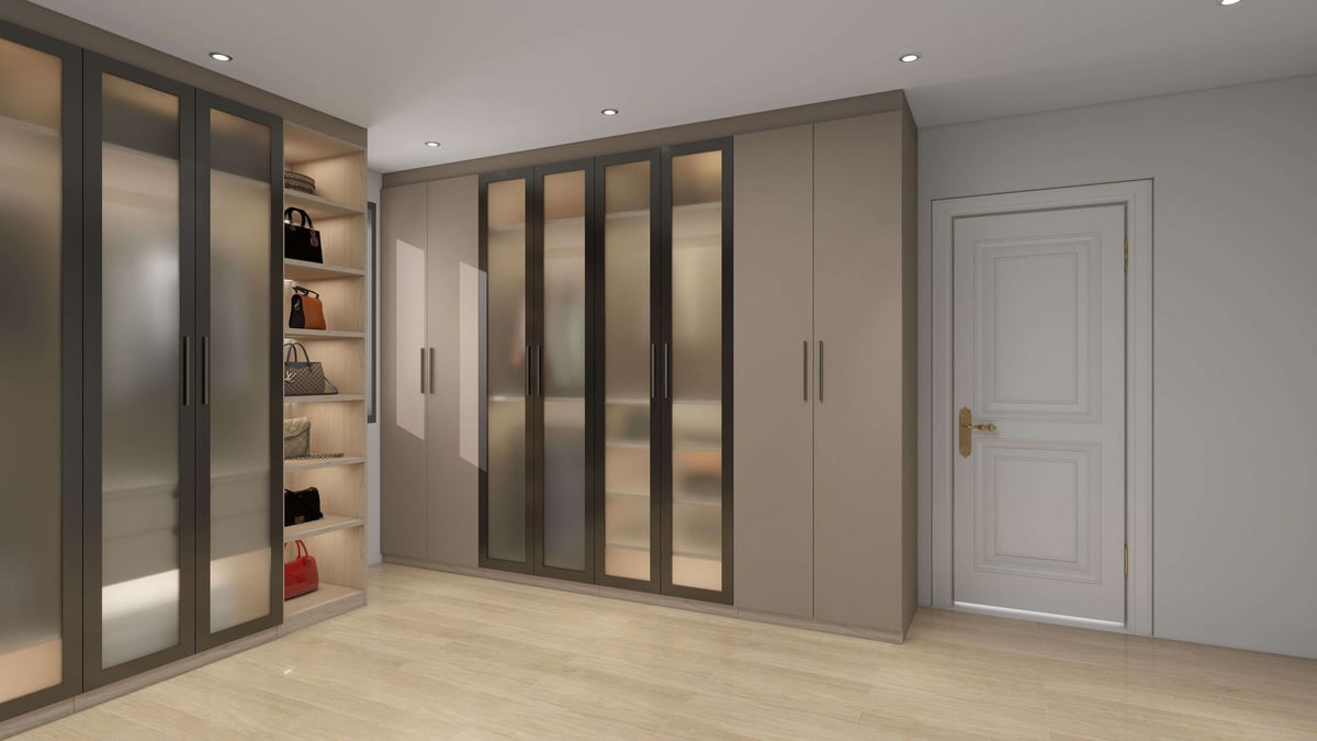 Modern walk-in closet with floor-to-ceiling gray and glass wardrobe doors, shelving, and light wood flooring