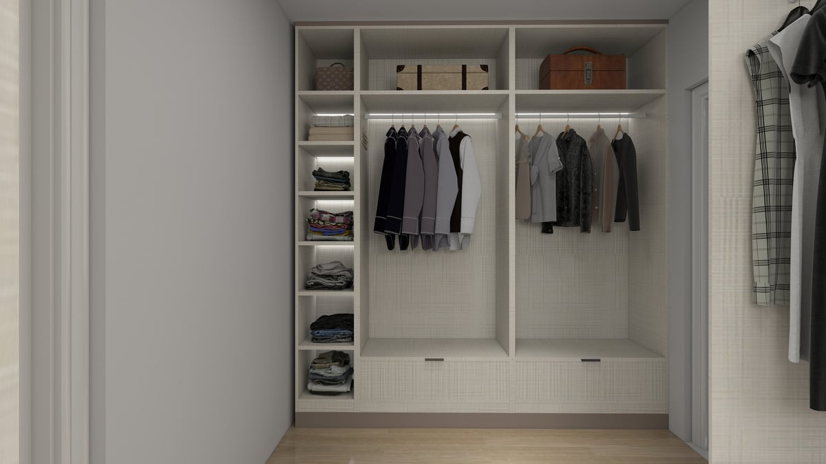 Modern walk-in closet with white shelving, hanging black and gray clothing on rods, and organized storage compartments