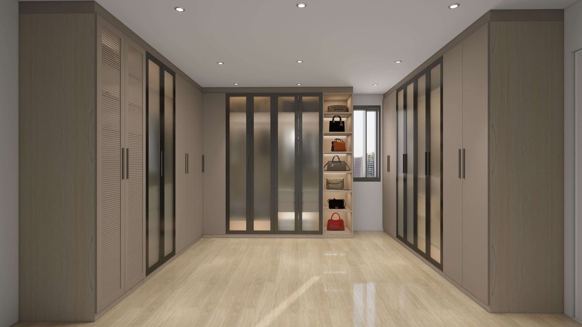 Modern walk-in closet with floor-to-ceiling built-in cabinetry, glass-panel sliding doors, and wooden flooring