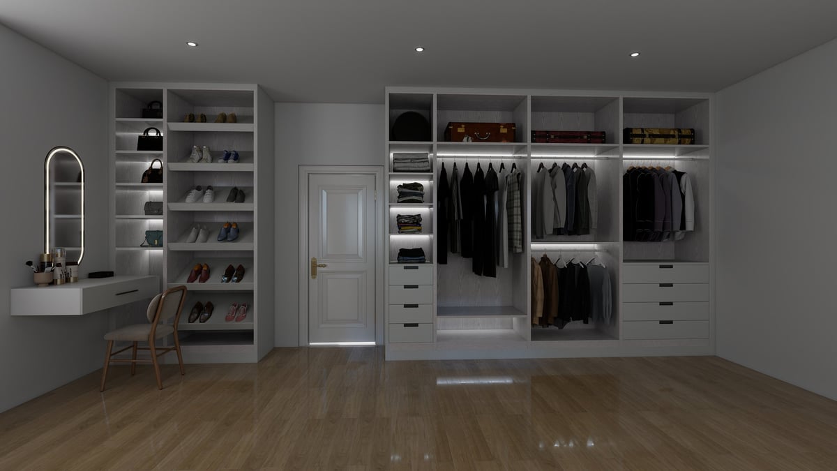 Modern walk-in closet with white shelving, hanging black clothing, shoe racks, and wooden floor.