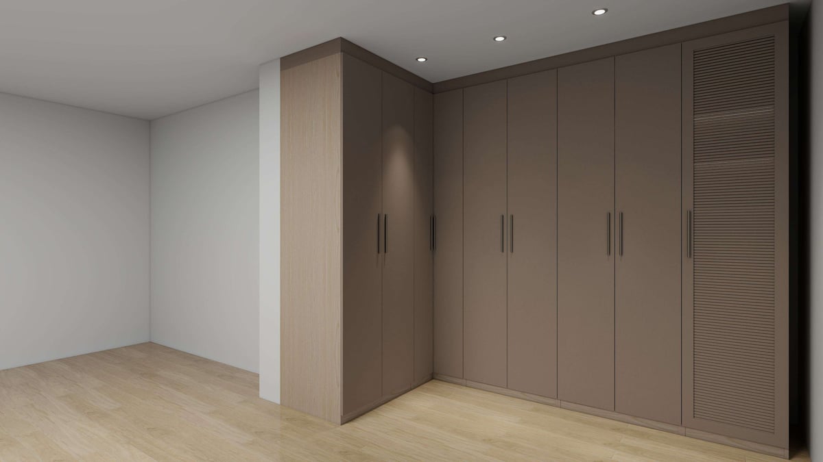 Modern bedroom with wood flooring and large built-in wardrobe with dark brown doors and handles
