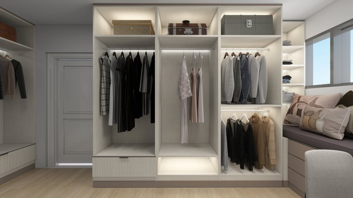 Modern open wardrobe closet system with white shelving displaying organized clothing, shoes, and accessories in a bedroom setting