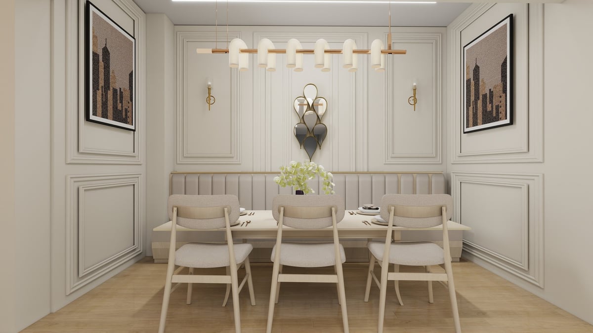 Modern dining room with cream-colored chairs around a table, neutral wall paneling, pendant lighting, and framed artwork on white walls